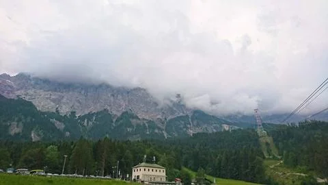 Dramatic view of the rugged Zugspitze mountain peak under a cloudy sky in the Stock Photos