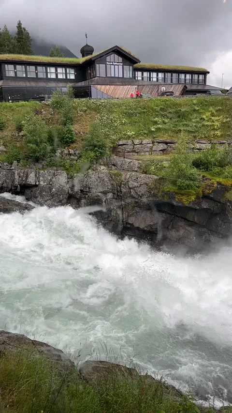 A dramatic view of rushing waters cascading near rugged mountains Stock Footage 316168490