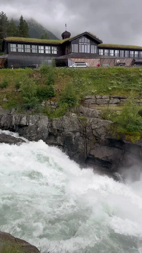 A dramatic view of rushing waters cascading near rugged mountains Stock Footage 316169272