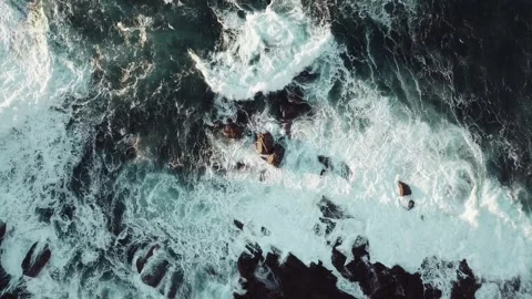 A dramatic view of the sea splashing against rocks 動画素材 246918332