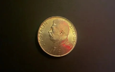 Dramatic view of Soviet-era Czech coin depicting Stalin. Stock Footage 261916205