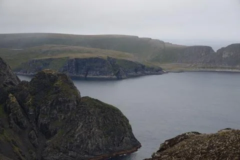 Dramatic view of steep cliff sides and jagged rocks along the Nordkapp coast  Stock Photos