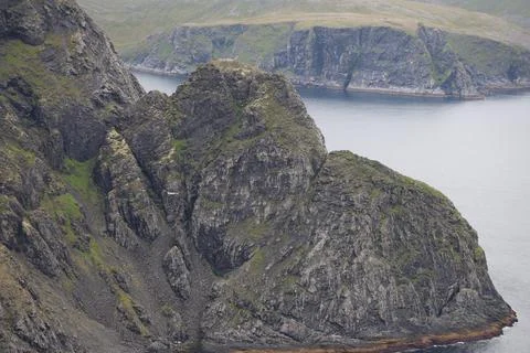 Dramatic view of steep cliff sides and jagged rocks along the Nordkapp coast  Stock Photos