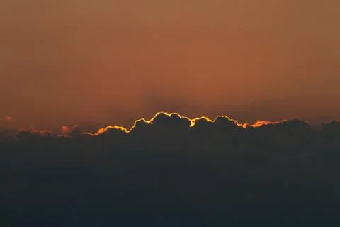 Dramatic view of the sunset with dark clouds. Stock Photos