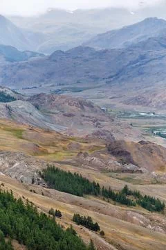 Dramatic view on wild altai mountains. In the background is the valley of t.. Stock Photos