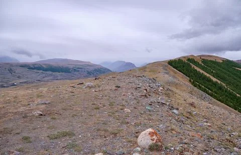 Dramatic view on wild altai mountains. In the background is the valley of t.. Stock Photos
