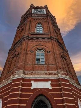 Dramatic view of Yelets Clock Tower showcasing historic architecture at sun.. Stock Photos