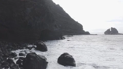 Dramatic volcanic coastline of La Palma, powerful waves surging against black Stock Footage 308400222