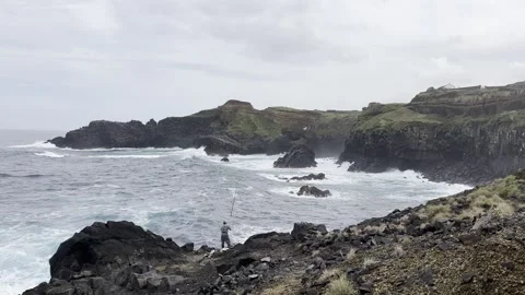 Dramatic volcanic coastline with rugged cliffs and ocean waves Stock Footage 327157859