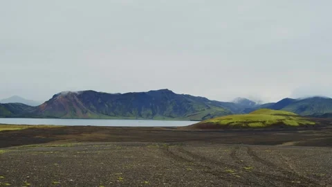 Dramatic Volcanic Landscape with Lake and Mountains in the Icelandic Highlands Stock Footage 320511908