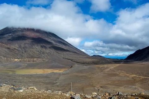 Dramatic Volcanic Landscape Under Cloudy Sky Stock Photos