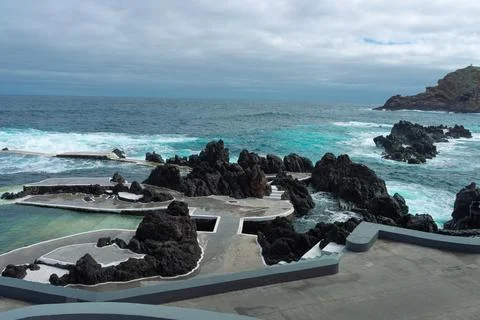 Dramatic Volcanic Ocean Pools with Waves and Cloudy Sky on a Rugged Coastli.. Stock Photos
