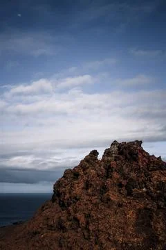 Dramatic Volcanic Peak Under a Blue Sky in the Galapagos Stock Photos