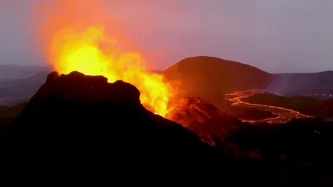 Dramatic volcano eruption spews molten lava and ash into dusky sky with glo.. Stock Footage 337749269