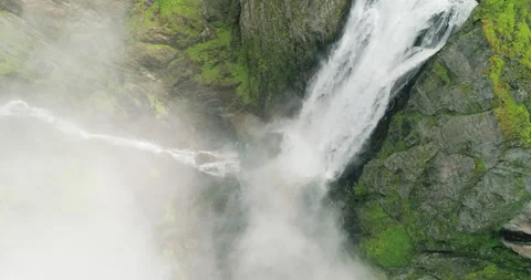 Dramatic Vøringsfossen waterfall rush splash down rocky foggy canyon; drone 스톡 동영상 202291432