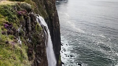Dramatic Waterfall Cascading From a Cliff Into The Sea Stock Footage 330314490