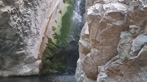 Dramatic waterfall in narrow Cyprus rocky gorge Stock Footage 328098065