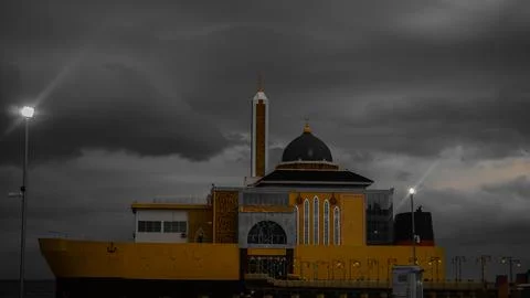 Dramatic Waterfront Building Against Cloudy Sky Fotos Stock