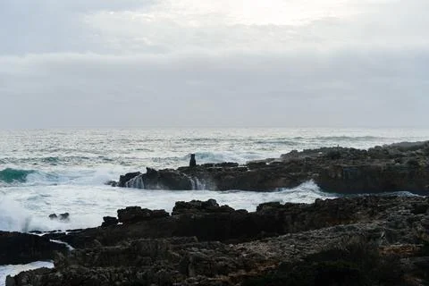 Dramatic waves crash against the rugged coastline of Cascais, Portugal, under Stock Photos