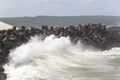 Dramatic Waves Crashing Against Tetrapod Sea Wall Stock Photos
