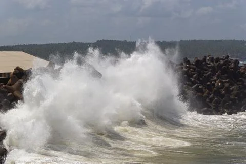 Dramatic Waves Crashing Against Tetrapod Sea Wall Stock Photos