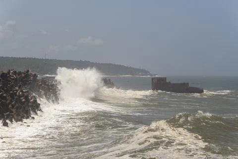 Dramatic Waves Crashing Against Tetrapod Sea Wall Stock Photos