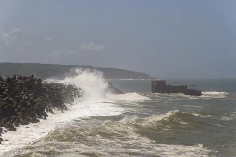 Dramatic Waves Crashing Against Tetrapod Sea Wall Stock Photos