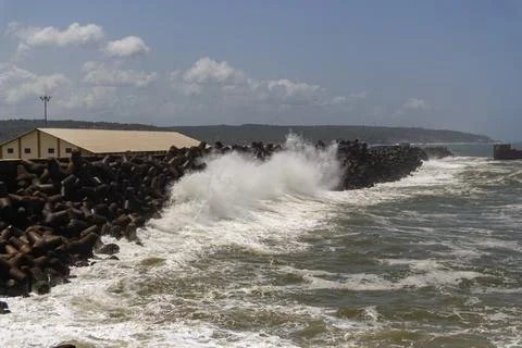Dramatic Waves Crashing Against Tetrapod Sea Wall Stock Photos