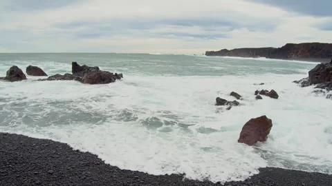 Dramatic Waves Crashing on a Black Sand Beach in Iceland Stock Footage 320228589