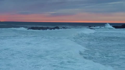 Dramatic Waves Crashing on Icelandic Shoreline at Sunset Stock Footage 320202290