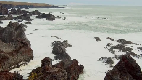 Dramatic Waves Crashing on Volcanic Rocks of the Icelandic Coast Stock Footage 320228923
