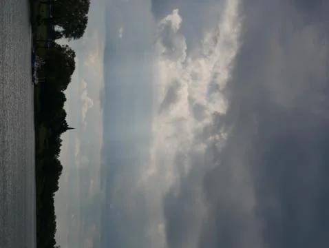 Dramatic weather in the sky, River Meuse, east bank as an almost silhouette-like Stock Photos