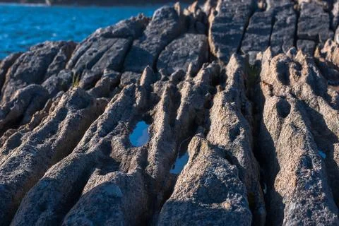 Dramatic Weathered Rock Formation with Blue Pools at Lofoten Norway Coast Stock Photos