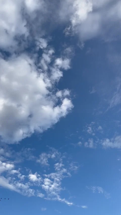 Dramatic white and gray clouds drifting across a deep blue sky. Stock Footage 345044697