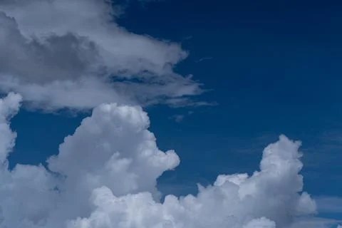 Dramatic White and Gray Cumulus Clouds on Deep Blue Sky Stock Photos