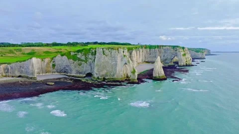 Dramatic white chalk cliffs of etretat coastline overlooking turquoise ocean Stock Footage 343696119