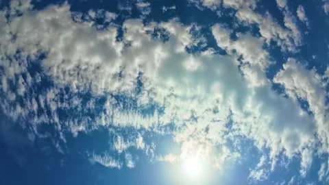 Dramatic white clouds across deep blue summer sky with bright sunlight. Sun rays Stock Footage 341952603
