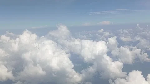 Dramatic white clouds are visible from the airplane window Stock Footage 311308082