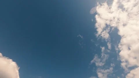 Dramatic white clouds drifting across a deep blue sky during a sunny day Stock Footage 342258663