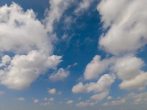 Dramatic White Clouds Framing a Bright Blue Sky on a Sunny Day Фото