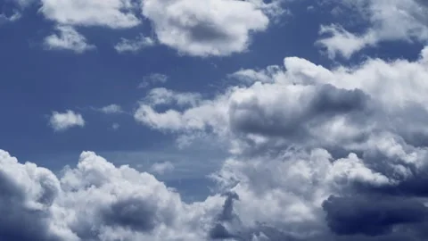 Dramatic white clouds moving across a deep blue sky Stock Footage 332726474