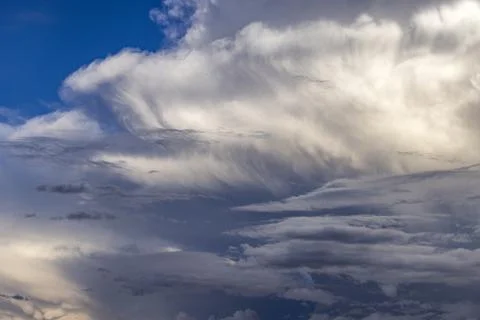 Dramatic white clouds in sunlight on blue sky Foto stock