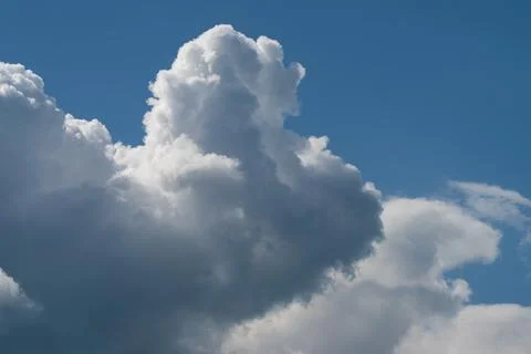 Dramatic white cumulus clouds against a bright blue sky Stock Photos