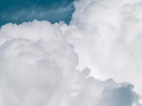 Dramatic white cumulus clouds billowing against deep blue sky, bold contras.. Stock Photos
