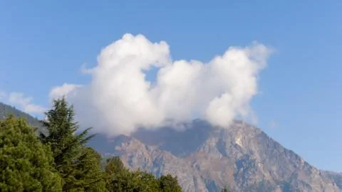 Dramatic white mist cloud floating over mountain. Blue sky backgrounds. Natur Stock Photos