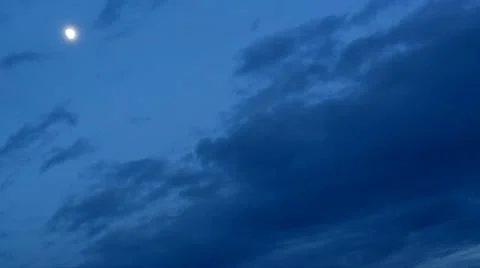 Dramatic white moon on blue sky during night and a bat 库存影片 12423531