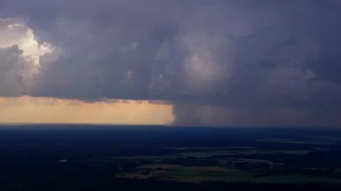 Dramatic wide aerial view of distant rain storm over expansive rural landscape Stock Footage 340863480