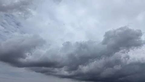 A dramatic wide shot captures a vast expanse of dark, heavy storm clouds fi.. Stock Photos