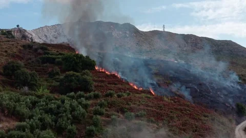 Dramatic Wildfire Spreading Across Mountainous Terrain in 4K Stock Footage 323277291