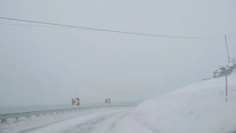A dramatic winter driving scene in Lofoten, Norway during snowstrom. Stock Footage 332628525